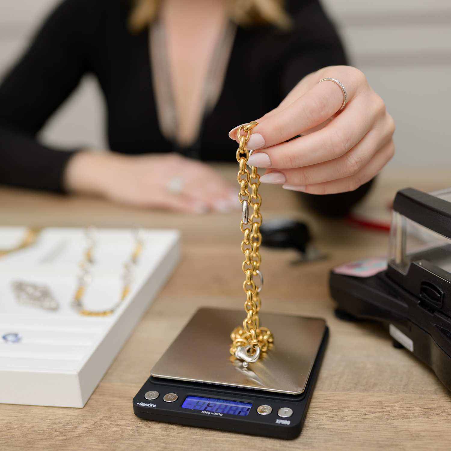Elegant gold chain being weighed on a digital scale, showcasing its premium quality and craftsmanship. Discover luxury jewelry at Devine Jeweler.