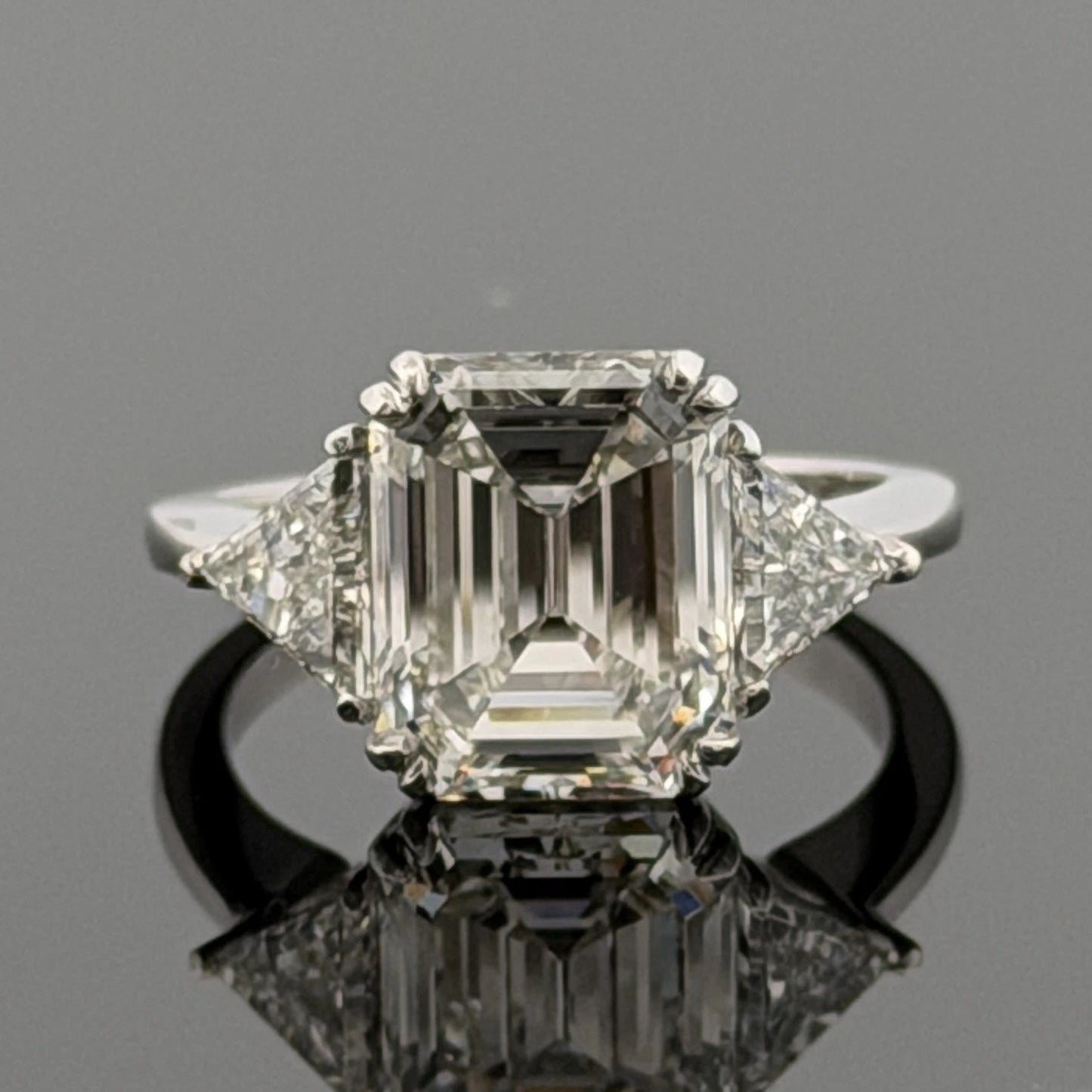 Platinum Three-Stone Ring 4.10ct Emerald Cut Natural Diamond GIA with Trillions by Devine & Co — front view