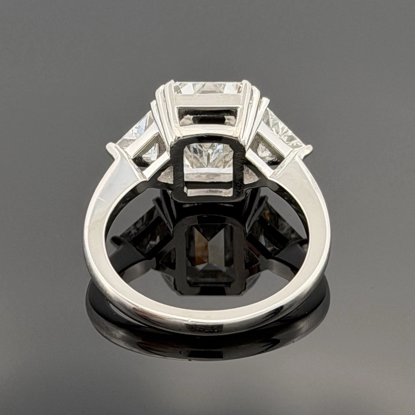 Platinum Three-Stone Ring 4.10ct Emerald Cut Natural Diamond GIA with Trillions by Devine & Co — angled view