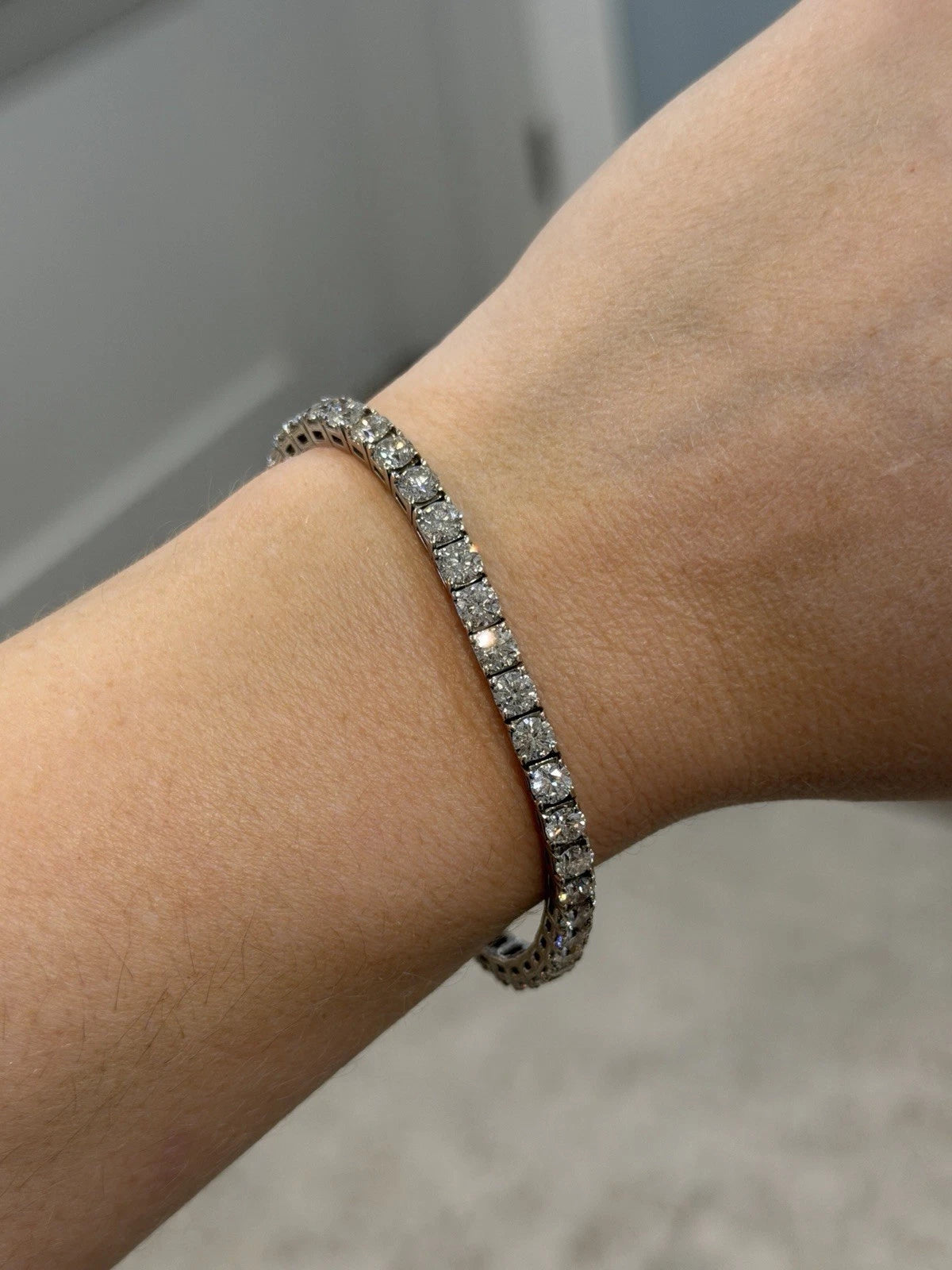 14K White Gold Natural Round Diamond Tennis Bracelet 9.80 ctw 7" G-H VS-SI by Devine & Co — angled view